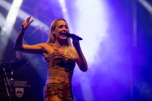 Ines Erbus performing with band at local student party.